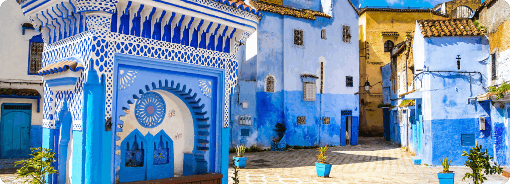 Vibrant blue streets of Chefchaouen, Morocco, showcasing traditional Moroccan architecture with intricate details, colorful doorways, and terracotta rooftops, ideal for travellers seeking authentic cultural experiences.