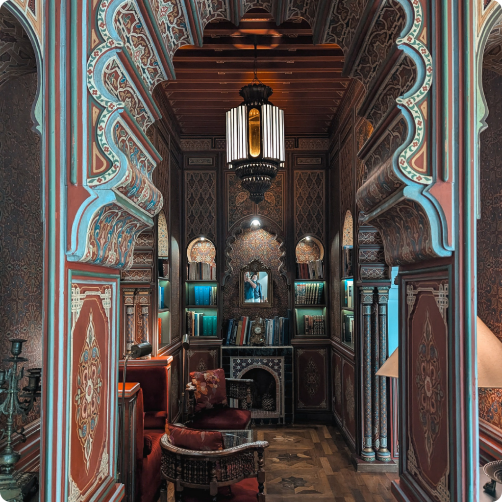 Elegant Moroccan riad interior featuring intricate zellige tilework, hand-carved arches, and traditional decor—ideal for travel advisors highlighting boutique stays that blend heritage, craftsmanship, and luxury in the heart of Morocco.
