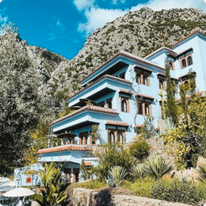 Charming blue guesthouse in Chefchaouen nestled against the Rif Mountains – ideal for travel advisors and tour operators seeking boutique stays with scenic views and local character in northern Morocco.